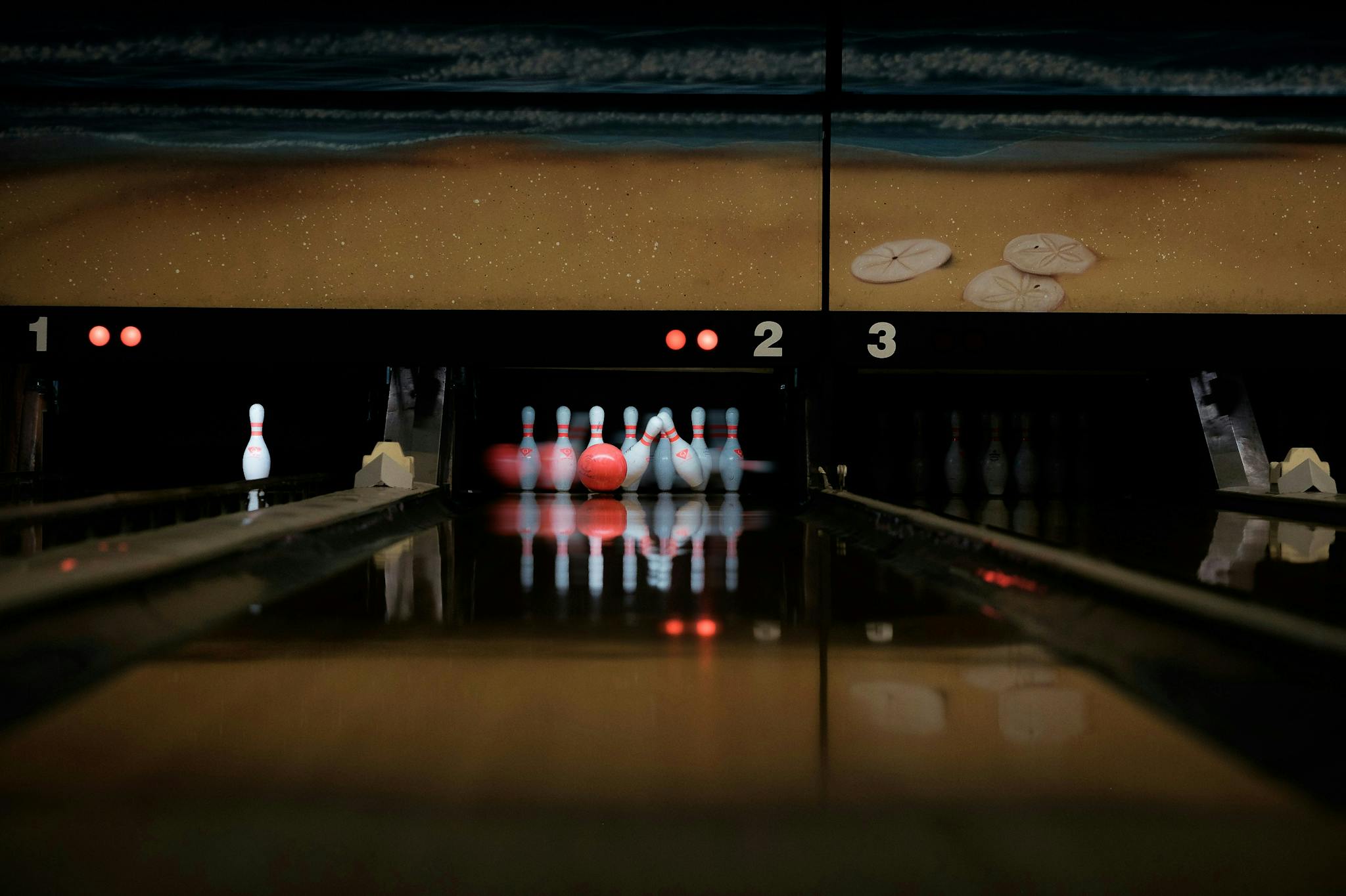bowling-alley-with-balls-rolling-towards-pins-on-multiple-lanes