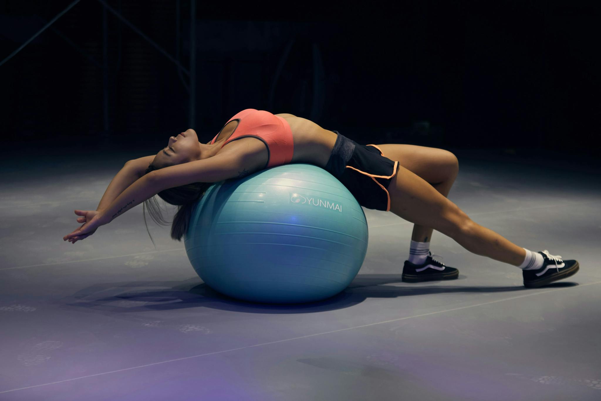 woman-doing-a-back-extension-exercise-on-a-fitness-ball