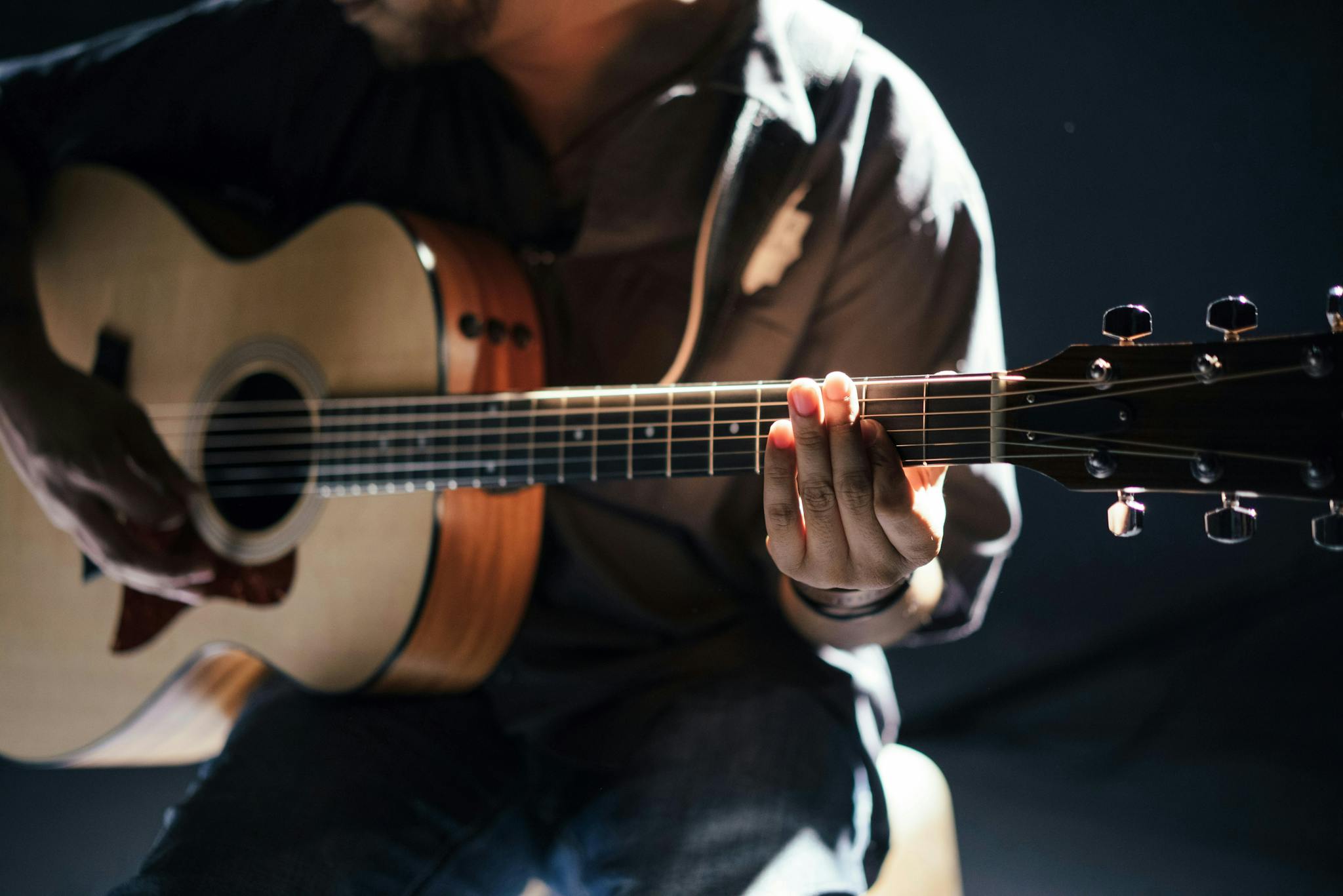 person-playing-an-acoustic-guitar